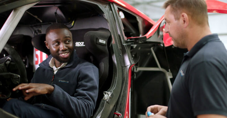 Mechanical engineer, George, sat in an electric car George talking to another person