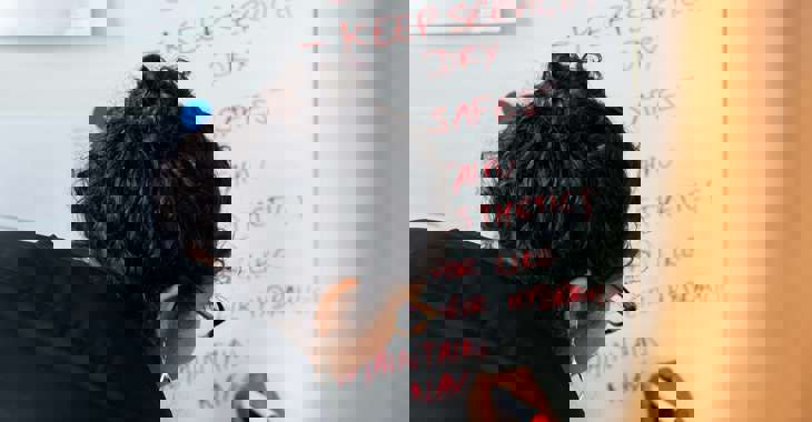 Female civil engineer presents the benefits of weirs on a white board 