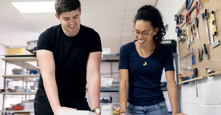 Man And Woman looking at something on a desk 