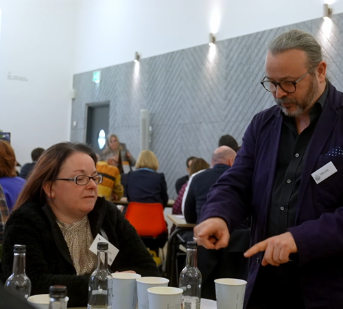 PASS Belfast Giles A Man Talks At A Table AI Summit Academy Staff